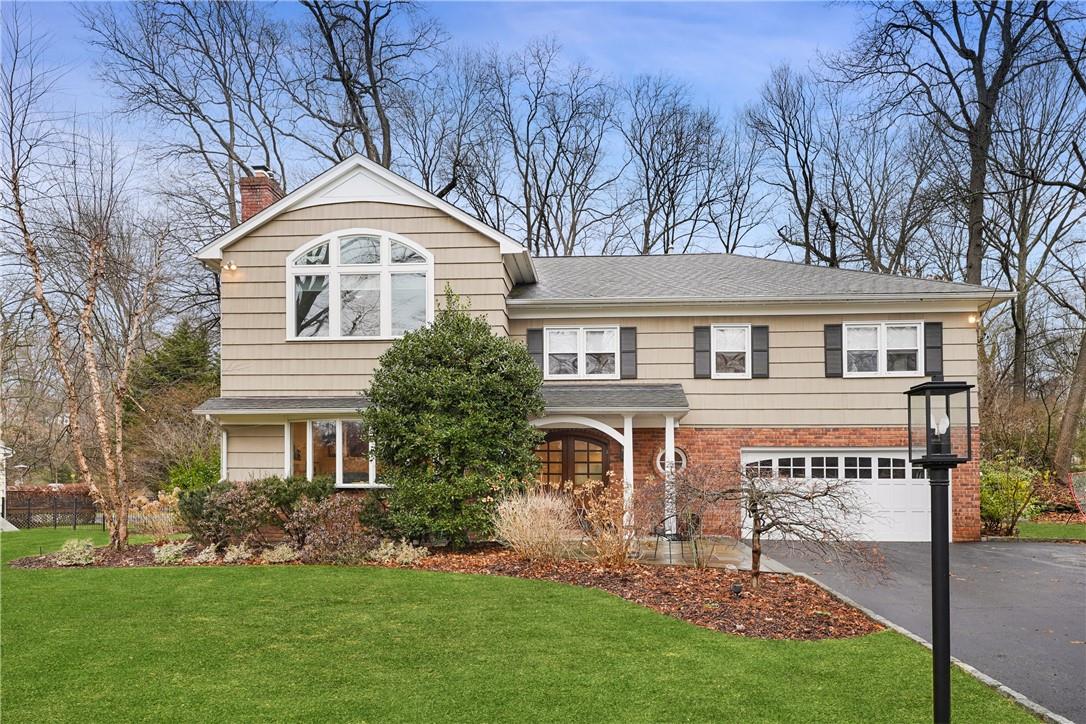 25 Meadowlark Road Rye Brook, NY 10573 - Photo 1 of 1 a front view of a house with a garden