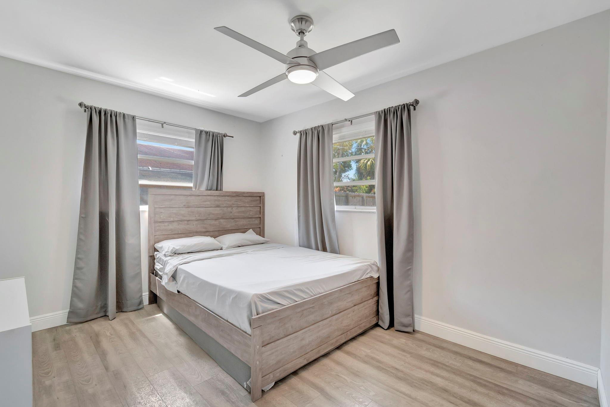1617 Northwest 4th Street Boca Raton, FL 33486 - Photo 23 of 45 a white bed sitting in a room next to a window