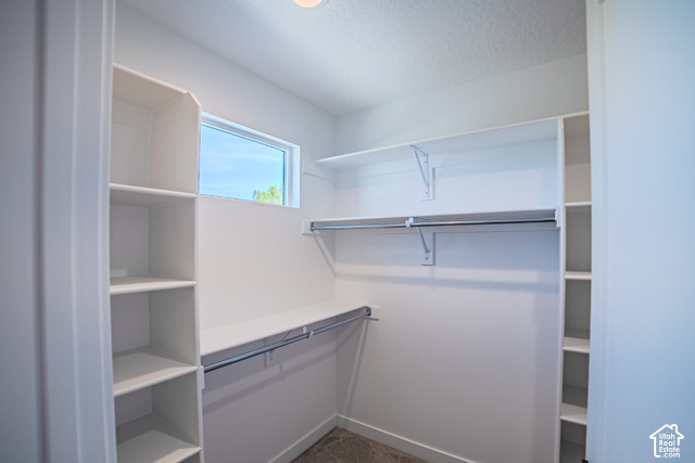 342 Perrine Drive Midvale, UT 84047 - Photo 23 of 37 White built-in shelving, chrome hanging rods, recessed lighting, and a horizontal window