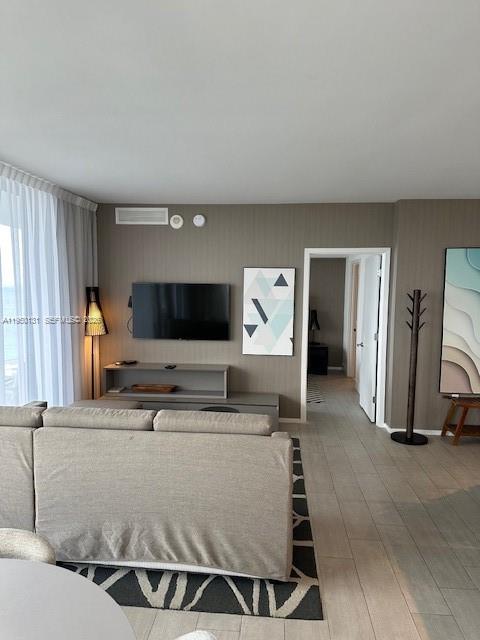 4010 South Ocean Drive, Unit R2702 Hollywood, FL 33019 - Photo 15 of 41 a living room with furniture and a flat screen tv
