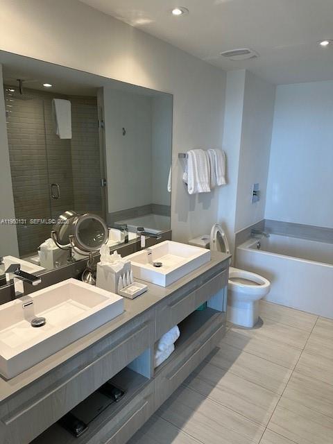 4010 South Ocean Drive, Unit R2702 Hollywood, FL 33019 - Photo 24 of 41 a bathroom with a double vanity sink toilet and a mirror