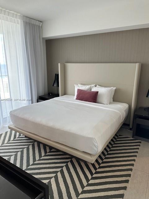 4010 South Ocean Drive, Unit R2702 Hollywood, FL 33019 - Photo 28 of 41 a bedroom with a bed and wooden floor