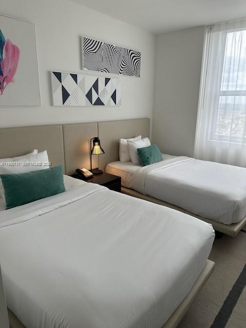 4010 South Ocean Drive, Unit R2702 Hollywood, FL 33019 - Photo 39 of 41 a bedroom with bed and window