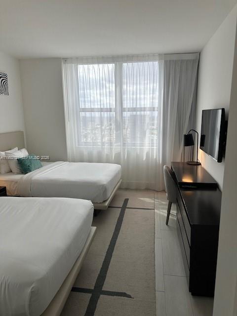 4010 South Ocean Drive, Unit R2702 Hollywood, FL 33019 - Photo 40 of 41 a bedroom with a bed and a window