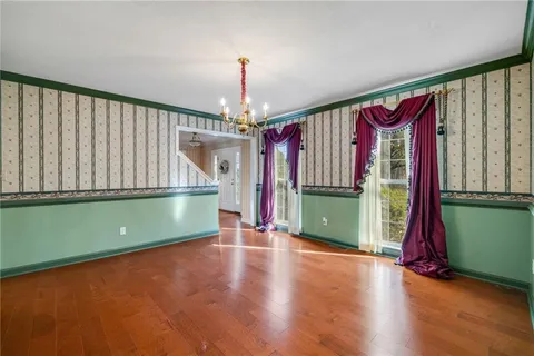 a view of a room with wooden floor and a window