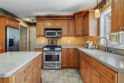 a kitchen with a sink stove and refrigerator