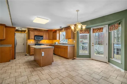 a kitchen that has a lot of cabinets and refrigerator
