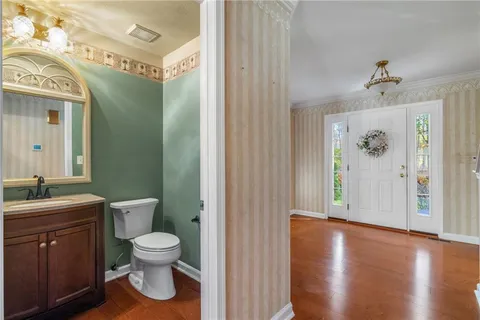 a spacious bathroom with a toilet sink and mirror