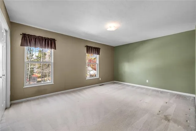 a view of an empty room with windows