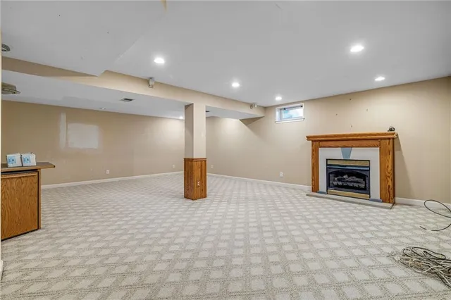 a view of an empty room with a fireplace