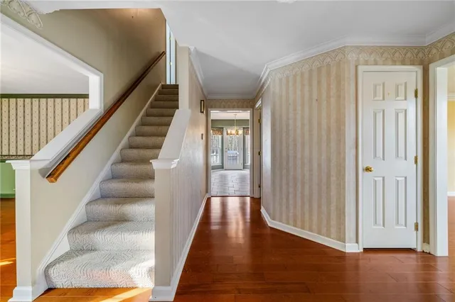 a view of a hallway with wooden floor and entryway