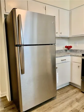 a white refrigerator freezer sitting in a kitchen