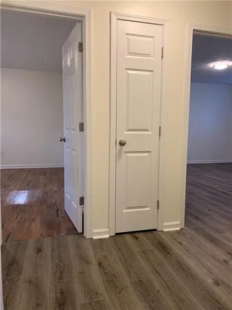 an empty room with wooden floor and closet