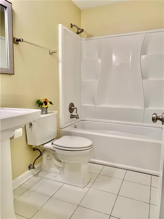 a bathroom with a toilet and a bath tub
