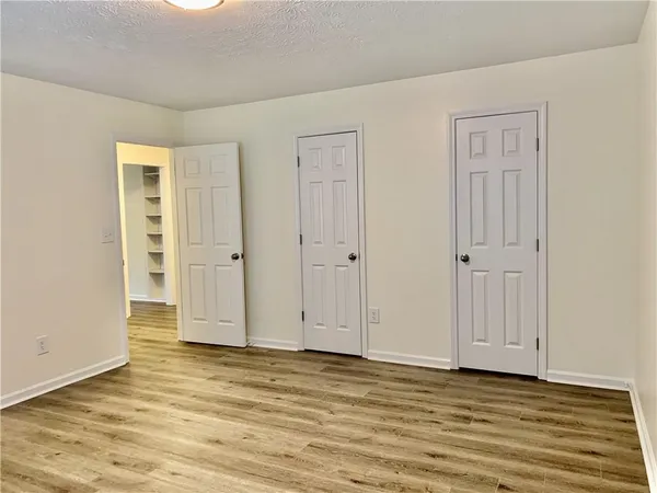 a view of wooden floor and closet area