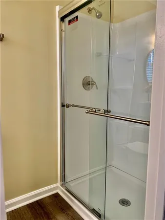 a bathroom with a glass shower door