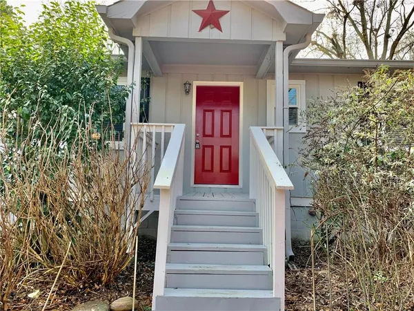 a front view of a house with a tree