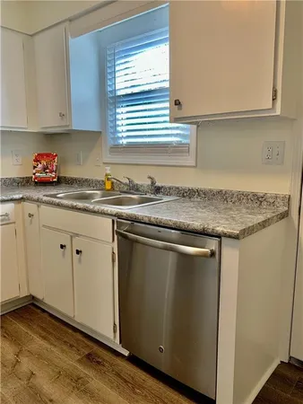 a kitchen with granite countertop cabinets sink and window