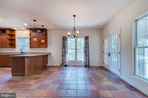 a view of a room with wooden floor and ceiling fan