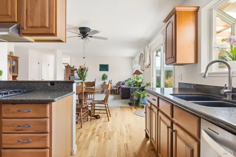 a kitchen with stainless steel appliances granite countertop sink stove and cabinets