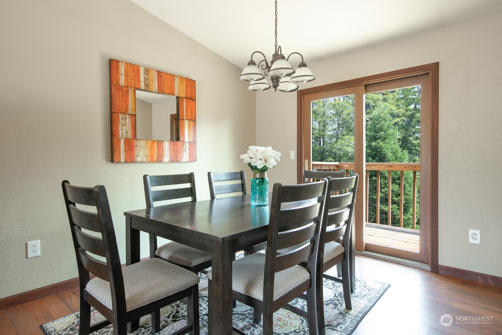7715 Lower Ridge Road Everett, WA 98203 - Photo 11 of 30 a view of a dining room with furniture a chandelier and wooden floor