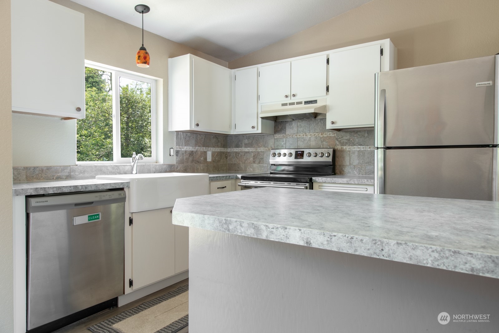 7715 Lower Ridge Road Everett, WA 98203 - Photo 16 of 30 a kitchen with stainless steel appliances granite countertop a refrigerator a sink dishwasher a stove and white countertops with wooden floor