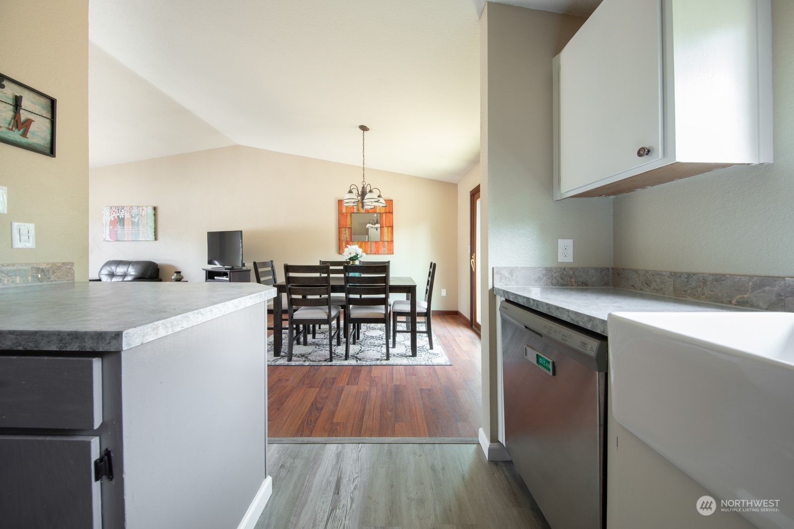 7715 Lower Ridge Road Everett, WA 98203 - Photo 17 of 30 a kitchen with stainless steel appliances a table and chairs in it