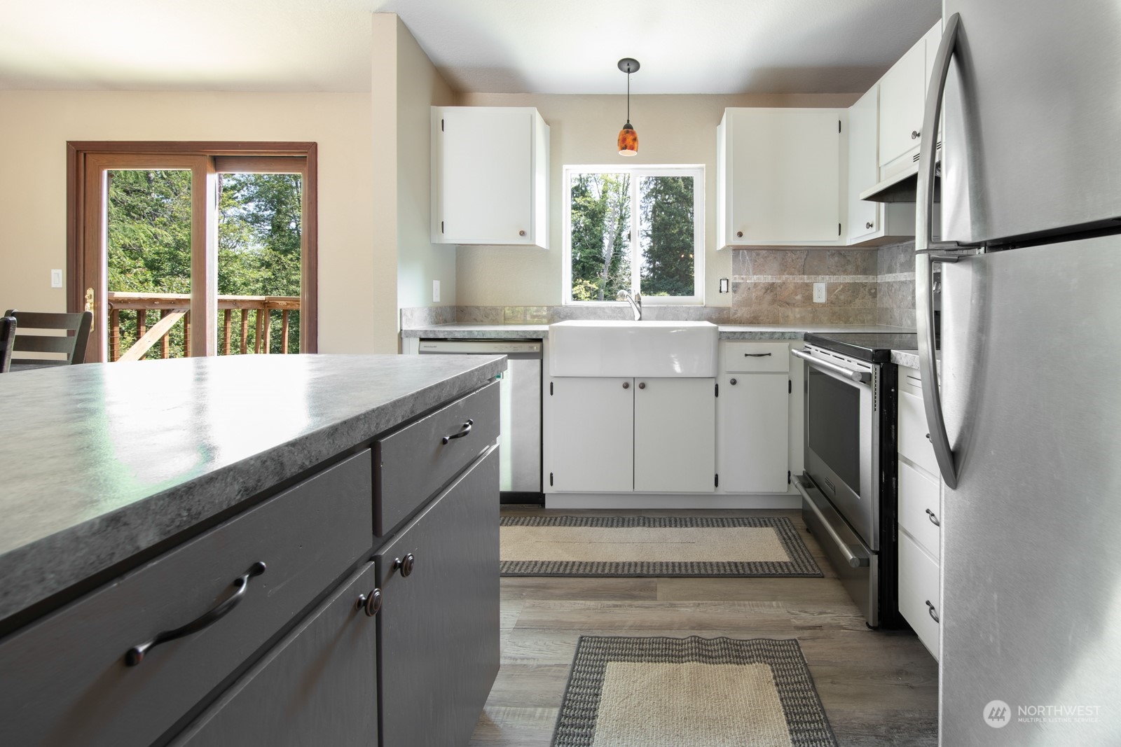 7715 Lower Ridge Road Everett, WA 98203 - Photo 18 of 30 a kitchen with white cabinets and a window
