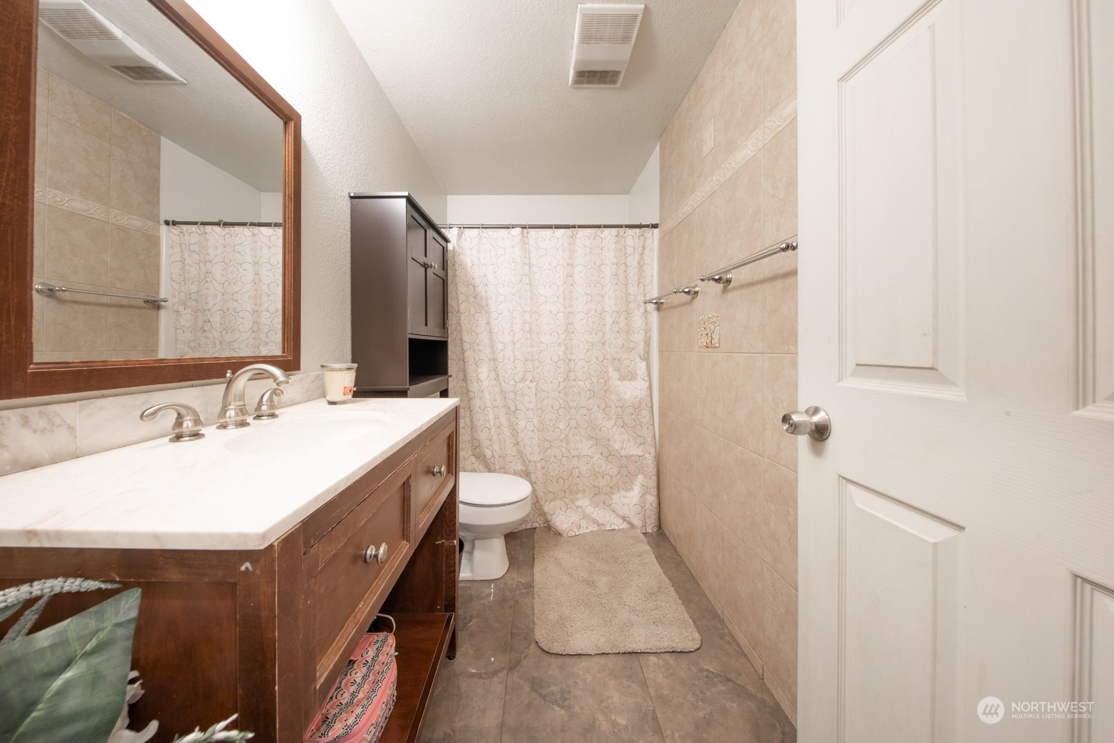 7715 Lower Ridge Road Everett, WA 98203 - Photo 24 of 30 a bathroom with a sink a toilet and shower