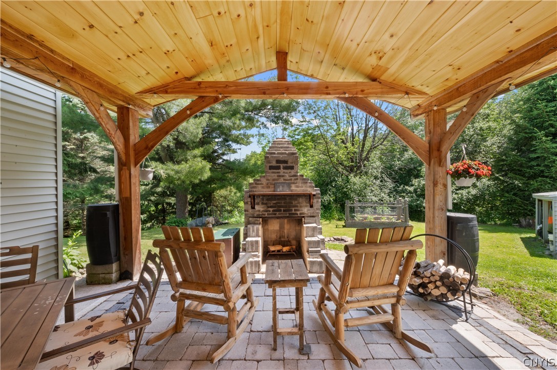 3546 Center Road Madison, NY 13402 - Photo 23 of 50 Covered patio to enjoy a nice fire. Notice the rain barrels on either side of the patio