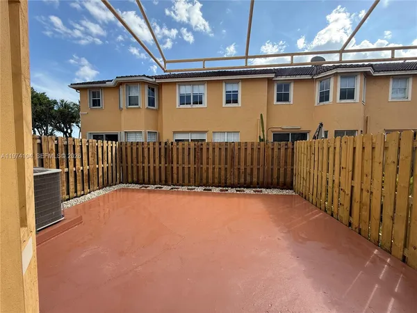 a view of a house with wooden fence
