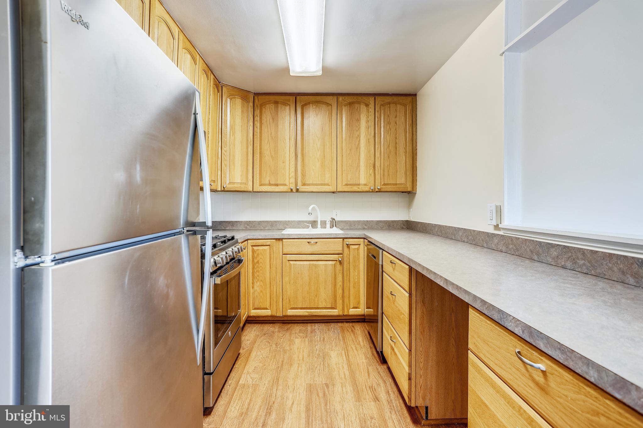 1111 University Boulevard West, Unit 208 Silver Spring, MD 20902 - Photo 14 of 61 Kitchen with larger wall cabinets and passthrough