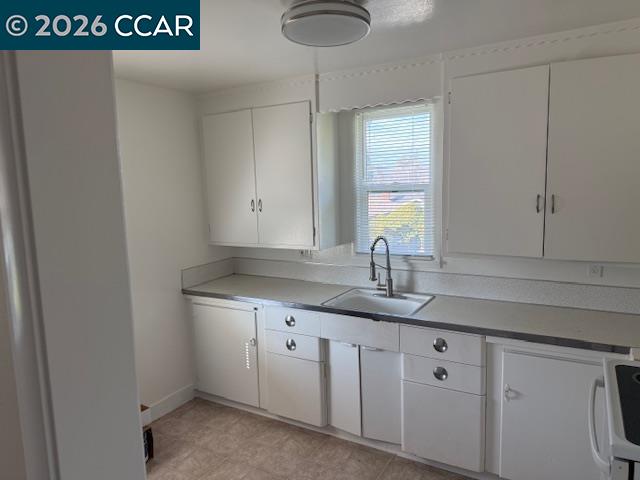 1830 Scott Road Concord, CA 94519 - Photo 5 of 12 a kitchen with sink cabinets and window