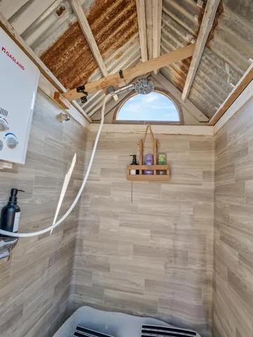 a front view of a house with glass windows and seating space