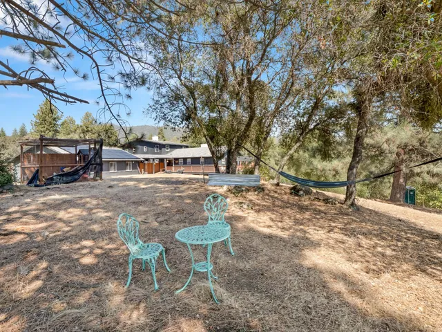 a view of a patio with a dining table and chairs