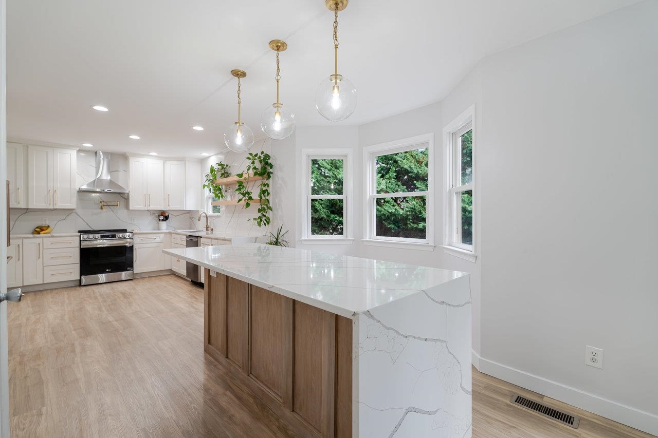 1271 King Edwards Way Harrisonburg, VA 22801 - Photo 15 of 75 a kitchen with kitchen island granite countertop a stove a sink a center island and windows
