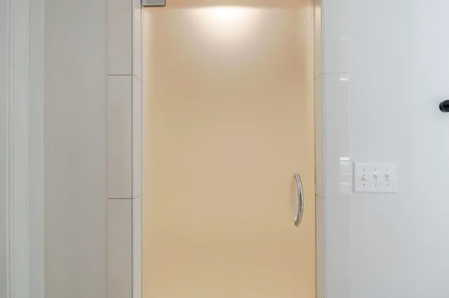 a view of a house with a yard and large tree