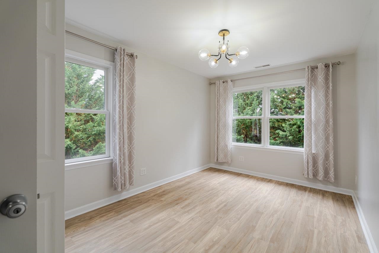1271 King Edwards Way Harrisonburg, VA 22801 - Photo 56 of 75 a view of an empty room with wooden floor and a window