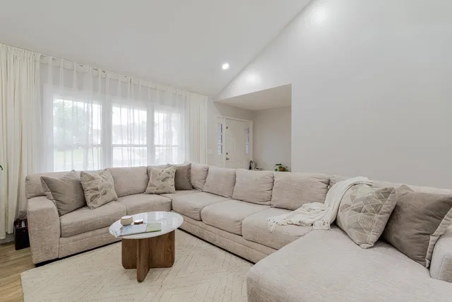 a view of a dining room with furniture wooden floor and windows