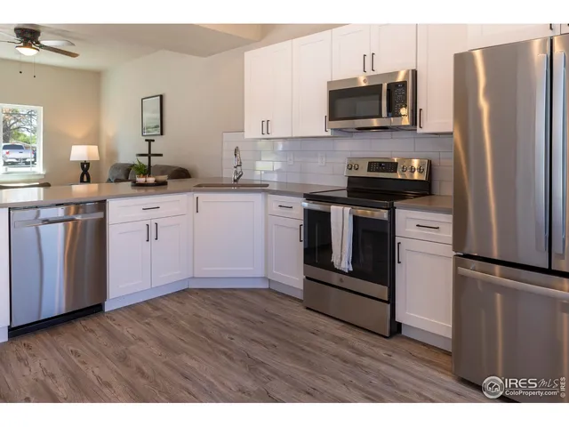 a kitchen with stainless steel appliances granite countertop a stove a refrigerator and a microwave