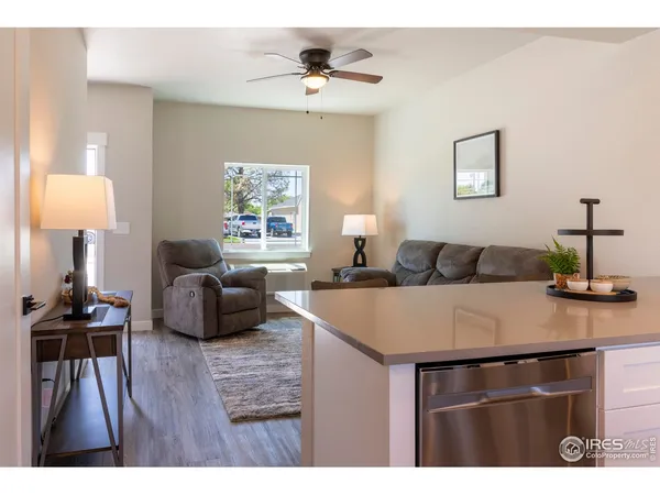 a living room with furniture a wooden floor and a chandelier