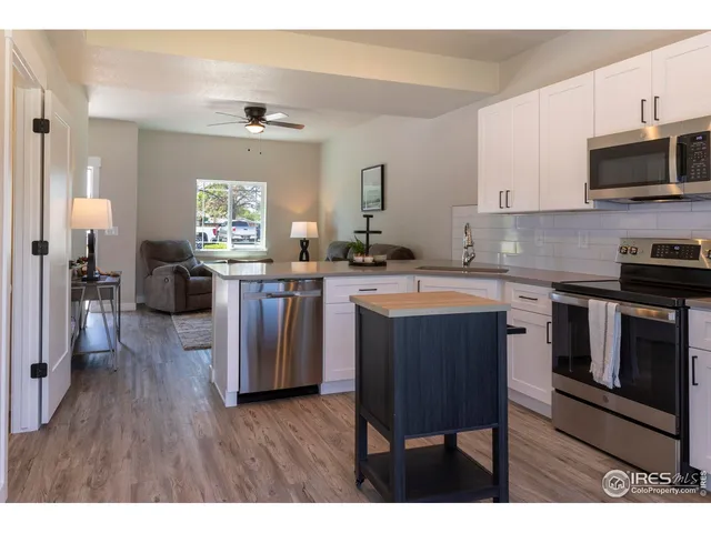 a kitchen with a sink cabinets and stainless steel appliances
