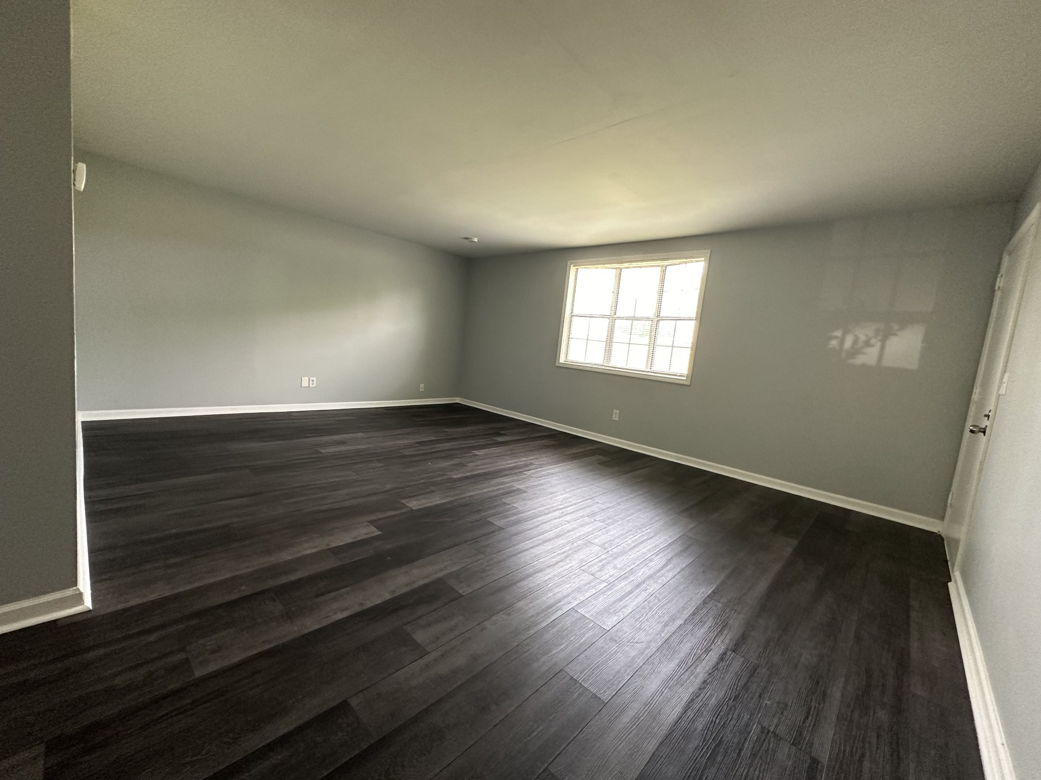 1301 Neelys Bend Road, Unit 52 Madison, TN 37115 - Photo 11 of 16 an empty room with wooden floor and windows