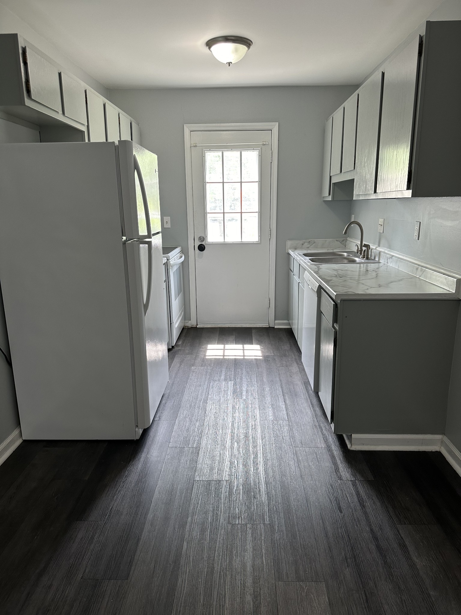 1301 Neelys Bend Road, Unit 52 Madison, TN 37115 - Photo 3 of 16 a kitchen with wooden floors and refrigerator