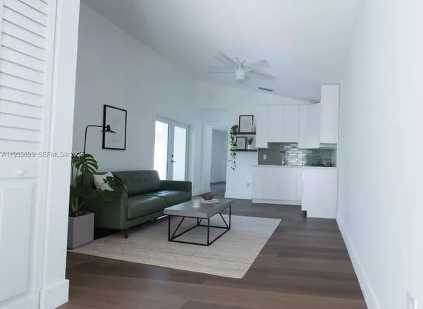 a living room with furniture and a rug