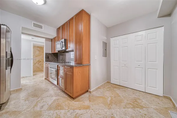 a kitchen with stainless steel appliances a refrigerator and a stove top oven