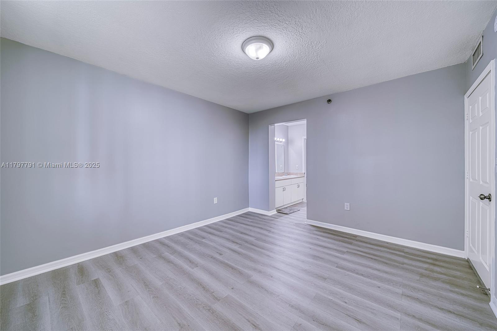 8888 Collins Avenue, Unit 201 Surfside, FL 33154 - Photo 19 of 37 a view of an empty room with wooden floor