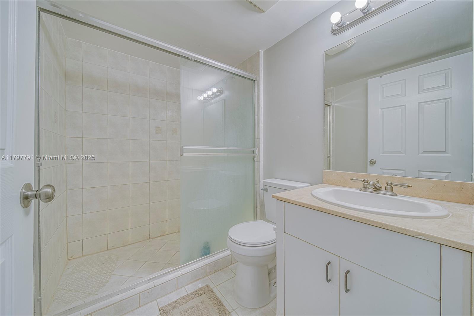 8888 Collins Avenue, Unit 201 Surfside, FL 33154 - Photo 8 of 37 a bathroom with a sink a toilet and shower