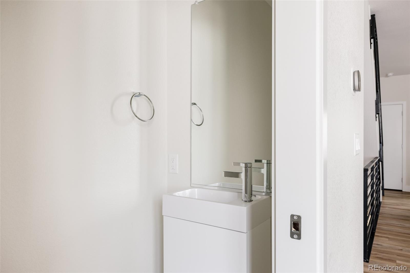 1179 South Reed Street Lakewood, CO 80232 - Photo 11 of 27 a bathroom with a sink and a mirror