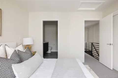a view of a bedroom with wooden floor